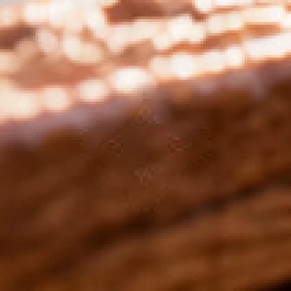 3D figurine on a wood desk: same corner after removal, 4× zoom